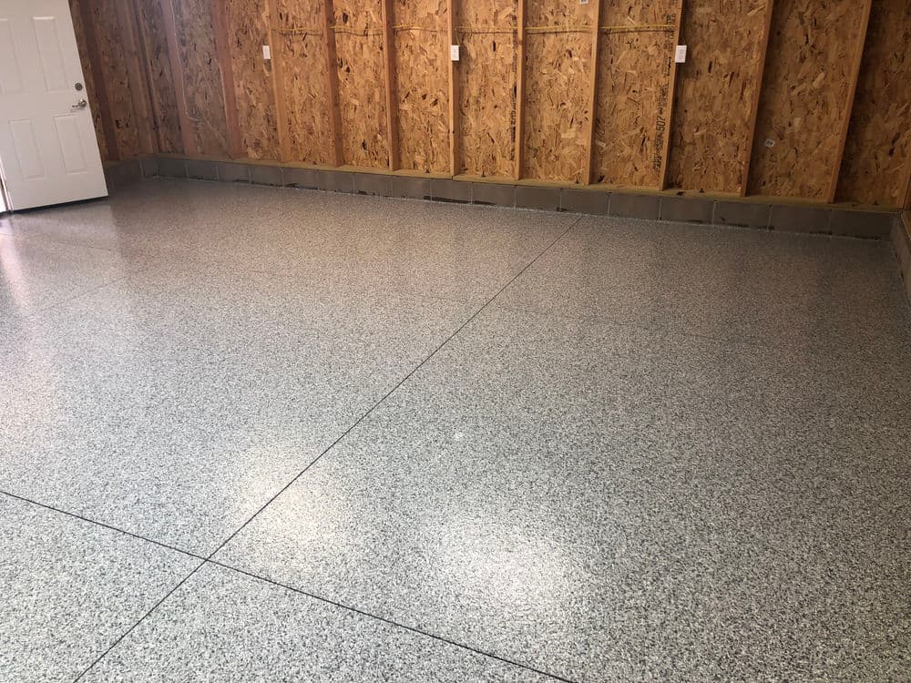 Polished epoxy garage floor with textured finish and wooden wall paneling.